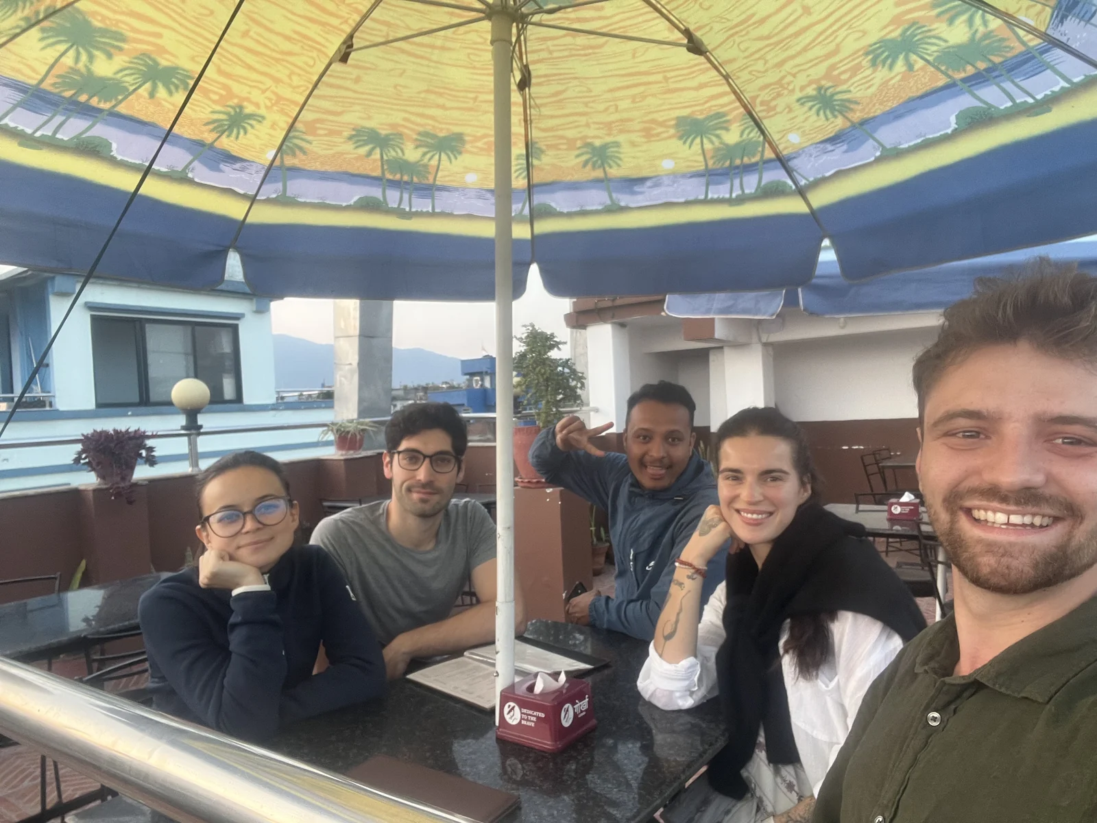 Robin and travelers gathered on a Kathmandu rooftop