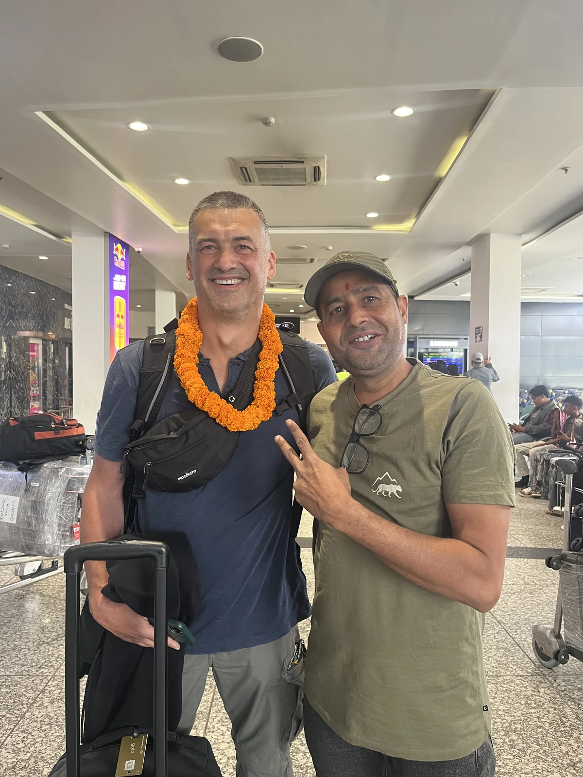Traveler greeted at the airport with a flower garland by our team